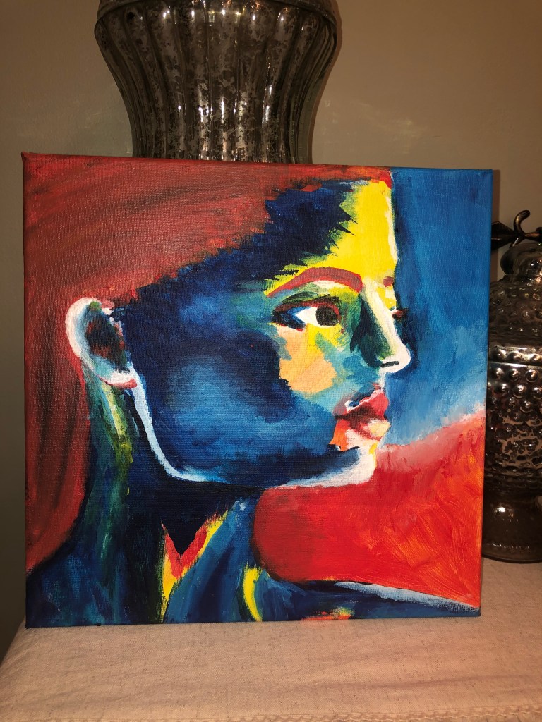 Painting of woman's face in hot and cool tones.