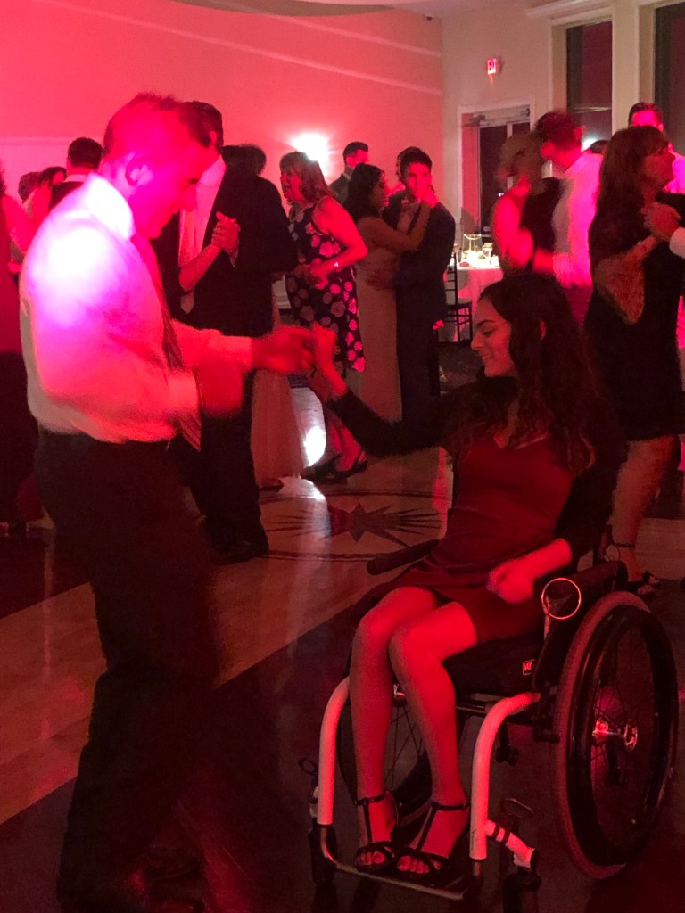 On the dance floor in my wheelchair with my dad.